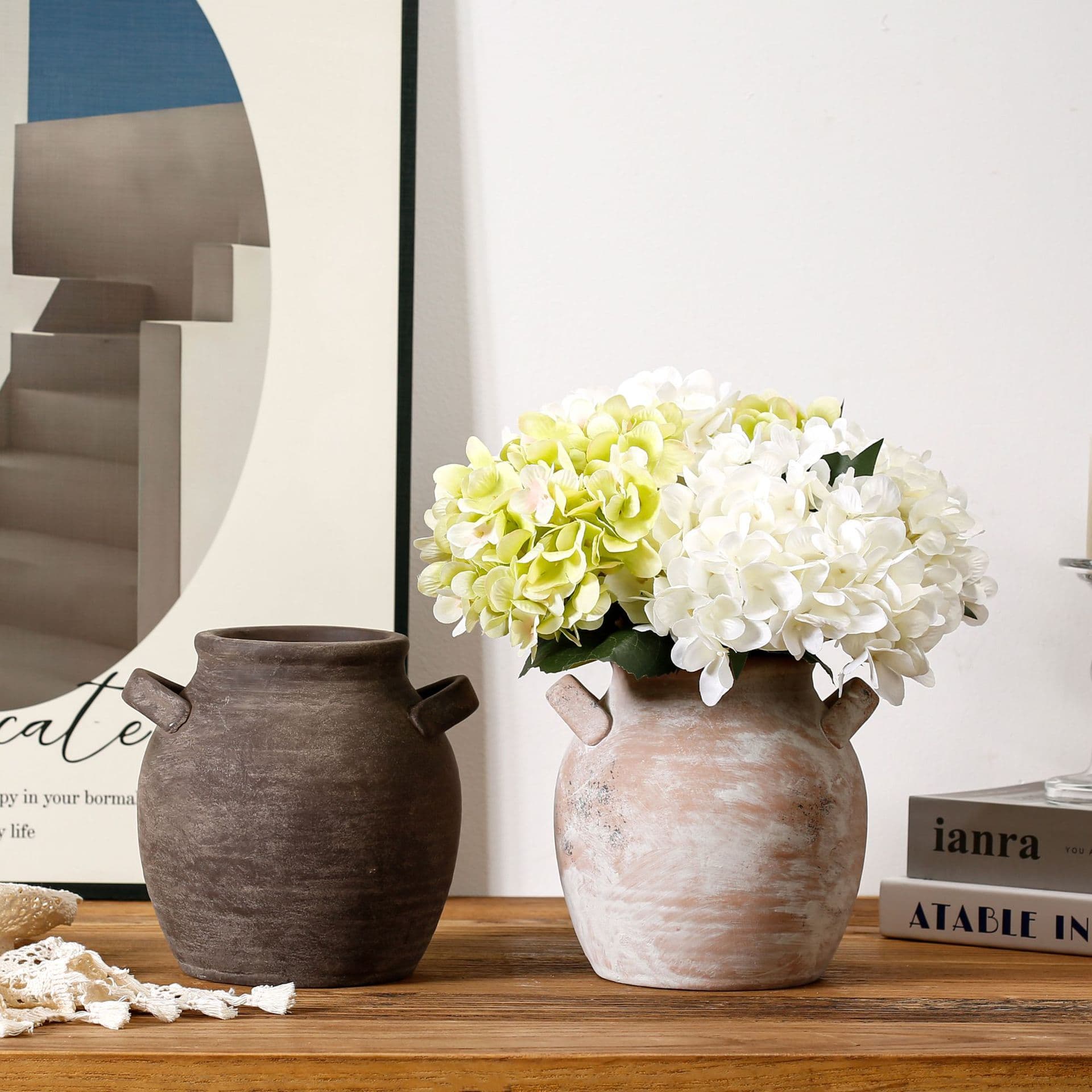 Retro handmade ceramic vases styled with hydrangeas on a shelf