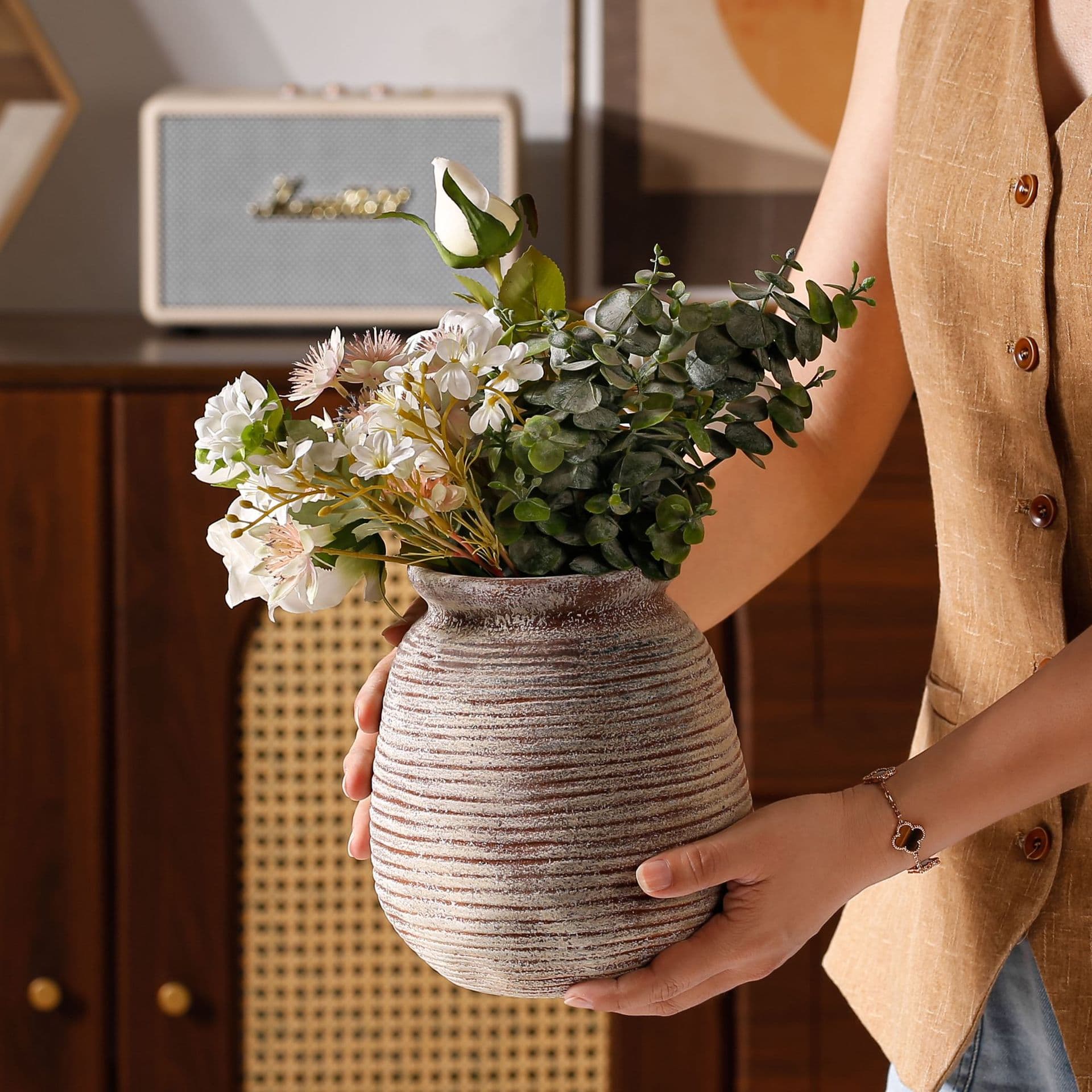 Antique taupe horizontal ribbed ceramic vase held in hand